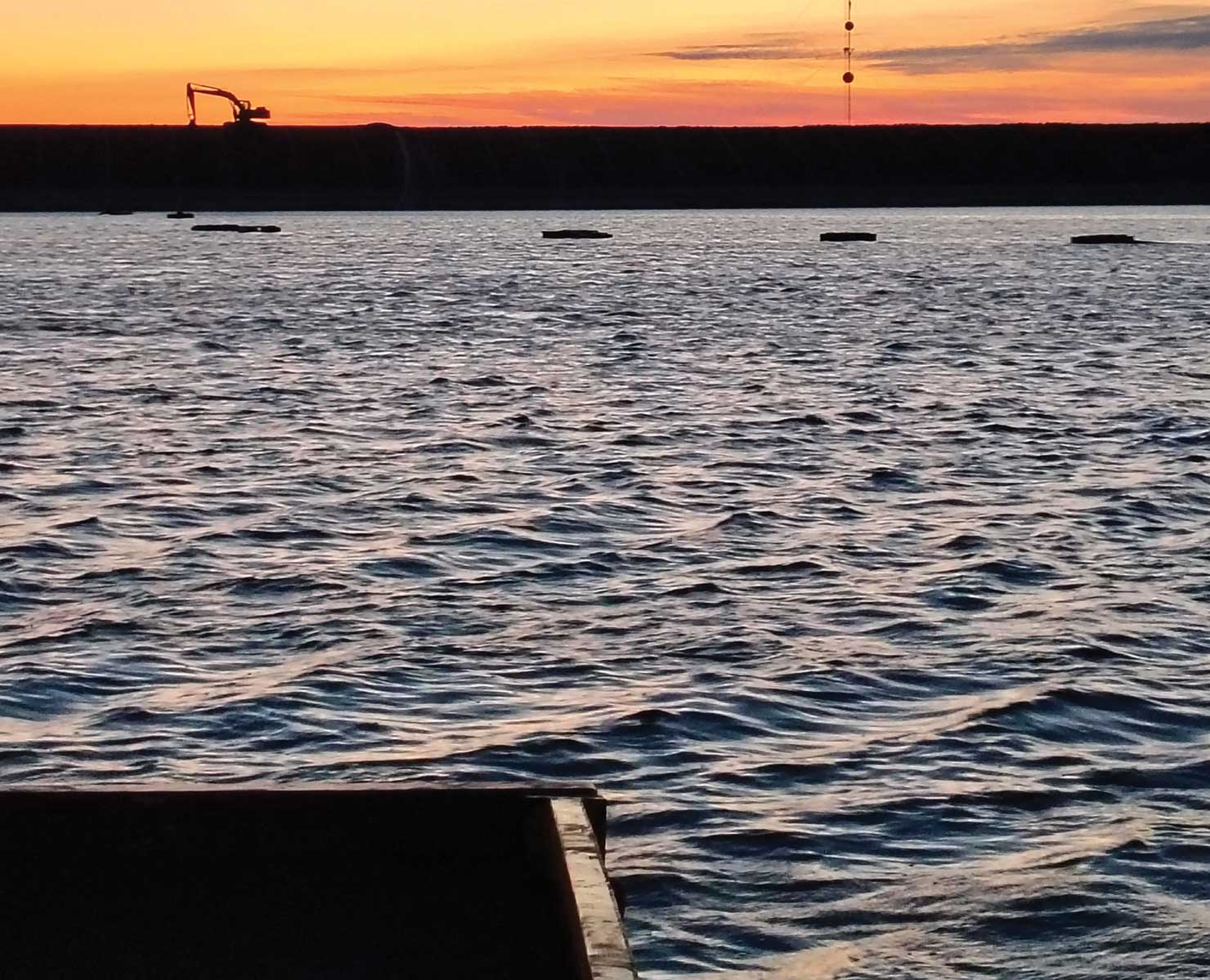 piney-point-4 Dredge discharge line on the water at the Piney Point project at sunset