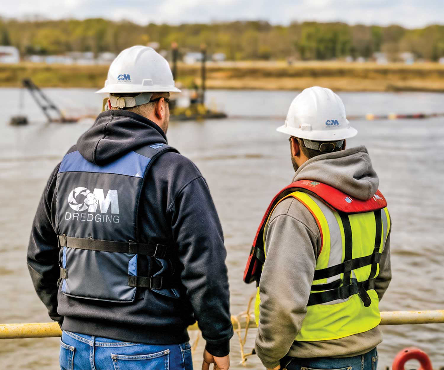 C&M Dredging crew members reviewing work on site