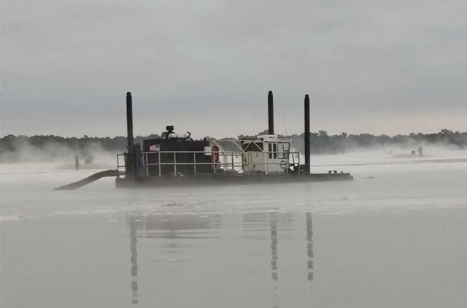 Industrial pond maintenance dredging site overview