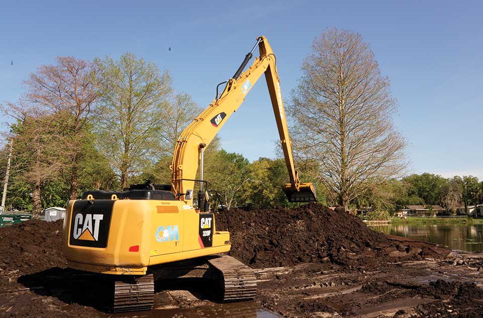 Excavator handling dewatered material at the Lake Lorraine staging site